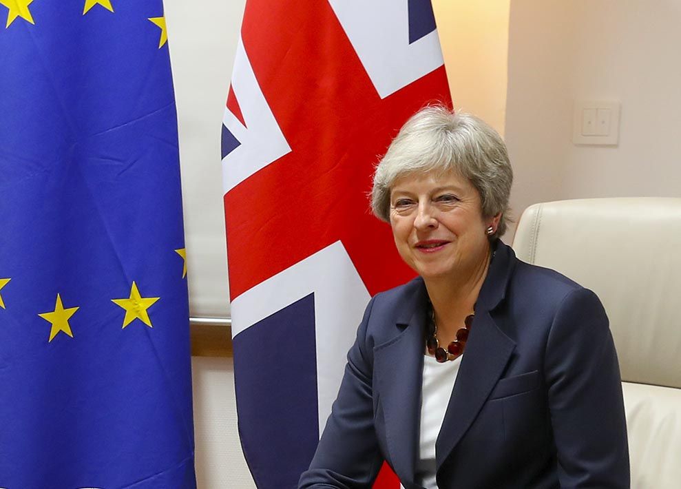 May in front of flags